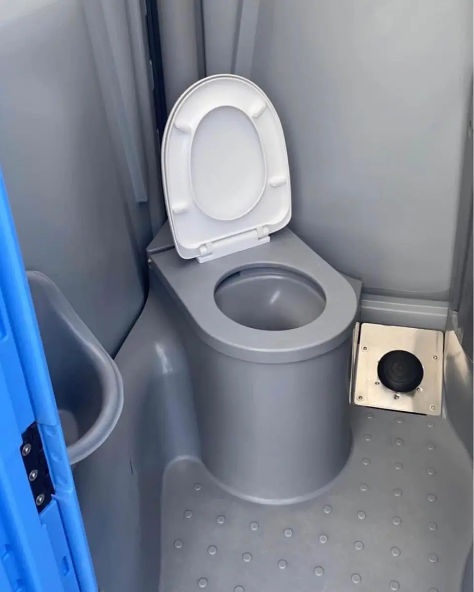 Spacious porta potty interior with a toilet seat and open floor space